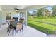 Relaxing screened patio, backyard view, dining table and grill at 4892 Hillman Ter, North Port, FL 34288