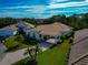 Aerial view of a house and surrounding neighborhood with lush landscaping at 5086 Faberge Pl, Sarasota, FL 34233