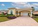 Single-story house with a driveway and lush landscaping at 5086 Faberge Pl, Sarasota, FL 34233