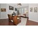 Bright living room with hardwood floors, wicker furniture, and large windows at 5086 Faberge Pl, Sarasota, FL 34233