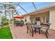 Spacious covered patio, with multiple seating areas, and access to interior at 5086 Faberge Pl, Sarasota, FL 34233