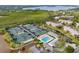 Aerial view of community tennis courts, pool, and clubhouse at 5179 Flicker Field Cir, Sarasota, FL 34231