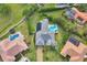 Aerial view of house with pool and solar panels, surrounded by lush landscaping at 5179 Flicker Field Cir, Sarasota, FL 34231