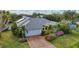 Single-story home with grey tile roof, solar panels, and lush landscaping at 5179 Flicker Field Cir, Sarasota, FL 34231