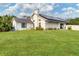 House with solar panels and a large grassy backyard at 5179 Flicker Field Cir, Sarasota, FL 34231
