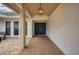 Covered entryway with a dark blue double door and a light-colored floor at 5179 Flicker Field Cir, Sarasota, FL 34231
