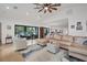 Spacious living area with a comfortable sectional sofa and pool access at 5179 Flicker Field Cir, Sarasota, FL 34231
