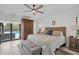 Large main bedroom with a king-size bed and access to the pool at 5179 Flicker Field Cir, Sarasota, FL 34231