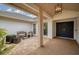 Courtyard entry with sitting area and a view of the front door at 5179 Flicker Field Cir, Sarasota, FL 34231