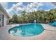Relaxing kidney-shaped pool with a spa and lounge chairs at 5179 Flicker Field Cir, Sarasota, FL 34231