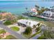 Single story home with circular driveway and canal views in a peaceful waterfront community at 548 Ketch Ln, Longboat Key, FL 34228
