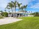 Spacious backyard with patio and tropical landscaping at 548 Ketch Ln, Longboat Key, FL 34228