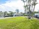 Lush lawn and canal-side boat dock at 548 Ketch Ln, Longboat Key, FL 34228