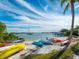 Colorful kayaks sit on a sandy beach, offering waterfront access and recreation at 548 Ketch Ln, Longboat Key, FL 34228