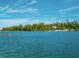 Kayakers paddle in calm waters, with lush greenery and a waterfront building in the background at 548 Ketch Ln, Longboat Key, FL 34228