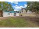 Large backyard with grassy area and partial fence at 554 Canal Rd, Sarasota, FL 34242