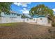Spacious backyard with a view of the home's rear at 554 Canal Rd, Sarasota, FL 34242