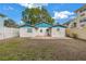 Fenced backyard with patio and grassy area at 554 Canal Rd, Sarasota, FL 34242