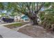 Quaint teal home with a large tree in the front yard at 554 Canal Rd, Sarasota, FL 34242