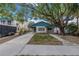 Charming teal home with a spacious yard and mature tree at 554 Canal Rd, Sarasota, FL 34242