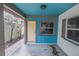 Covered porch with yellow door and blue ceiling at 554 Canal Rd, Sarasota, FL 34242