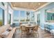 Bright breakfast nook with water views and wicker chairs at 560 Harbor Point Rd, Longboat Key, FL 34228