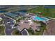 Aerial view of community with pool, tennis courts, and clubhouse at 5904 Wake Forest Run # 102, Bradenton, FL 34211