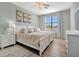 Relaxing bedroom with light walls and a comfy bed at 5904 Wake Forest Run # 102, Bradenton, FL 34211