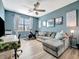 Versatile bonus room with a sectional sofa and home office setup at 5904 Wake Forest Run # 102, Bradenton, FL 34211
