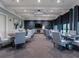 Elegant clubhouse dining area with modern furnishings and large screen TV at 5904 Wake Forest Run # 102, Bradenton, FL 34211
