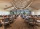 Bright dining room with numerous tables and chairs, offering ample space at 5904 Wake Forest Run # 102, Bradenton, FL 34211