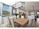 Open concept dining area with kitchen view, large table and chandelier at 5904 Wake Forest Run # 102, Bradenton, FL 34211
