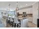 Modern kitchen with large island, stainless steel appliances, and white cabinets at 5904 Wake Forest Run # 102, Bradenton, FL 34211