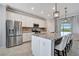 Modern kitchen with granite island, stainless steel appliances, and white cabinets at 5904 Wake Forest Run # 102, Bradenton, FL 34211