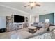 Spacious living room with sectional sofa, large TV, and built-in shelving at 5904 Wake Forest Run # 102, Bradenton, FL 34211