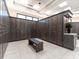 Well-lit room with numerous wood lockers and a bench at 5904 Wake Forest Run # 102, Bradenton, FL 34211