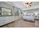 Main bedroom with king-size bed, large mirror and dresser at 5904 Wake Forest Run # 102, Bradenton, FL 34211