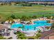 Resort-style pool with waterfall feature and surrounding lounge chairs at 5904 Wake Forest Run # 102, Bradenton, FL 34211