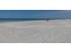 Expansive beach view with tranquil ocean and clear sky at 600 Fox St, Longboat Key, FL 34228