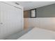 Bedroom with white built-in closet and gray accent wall at 600 Fox St, Longboat Key, FL 34228