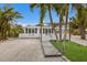 Charming house featuring a pergola and well-manicured lawn at 600 Fox St, Longboat Key, FL 34228