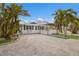Quaint cottage with white picket fence and tropical landscaping at 600 Fox St, Longboat Key, FL 34228