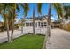 Front yard view of a beach-style cottage with walkway at 600 Fox St, Longboat Key, FL 34228
