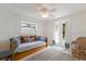 Bright guest room with daybed, French doors, and wicker chair at 600 Fox St, Longboat Key, FL 34228