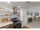 Modern kitchen with stainless steel appliances and white cabinets at 600 Fox St, Longboat Key, FL 34228