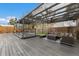 Pergola-covered patio with dining and seating areas at 600 Fox St, Longboat Key, FL 34228