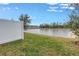 Grass backyard with lake view and fence at 6111 Fairmont Ln, Palmetto, FL 34221