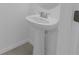 Simple pedestal sink in a small bathroom at 6111 Fairmont Ln, Palmetto, FL 34221