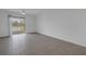 Bright bedroom with tile floors and sliding glass doors leading to a lake view at 6111 Fairmont Ln, Palmetto, FL 34221