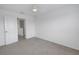 Bedroom with grey carpet and door to hallway and loft at 6111 Fairmont Ln, Palmetto, FL 34221